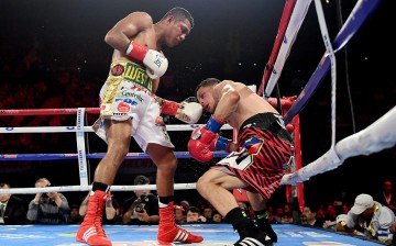 Roman Gonzalez punches McWilliams Arroyo on way to a unanimous 12 round decision during a WBC flyweight title fight at The Forum on April 23, 2016 in Inglewood, California.