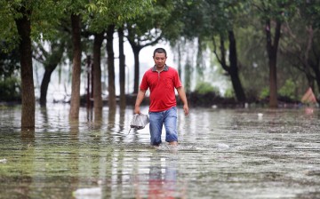 A villager walking in the flood of Niushan Lake on July 14, 2016 in Wuhan, Hubei Province, China.