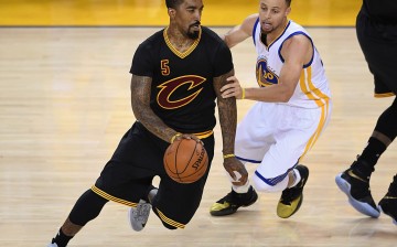 Cleveland Cavaliers shooting guard JR Smith (L) drives past Golden State Warriors' Stephen Curry.