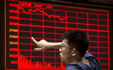 A Chinese day trader reacts as he watches a stock ticker at a local brokerage house on August 27, 2015 in Beijing, China.