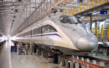 Mechanics check a high-speed train at Xi'an Electric Multiple Unit (EMU) Maintenance Base on January 7, 2014 in Xi An, China. 