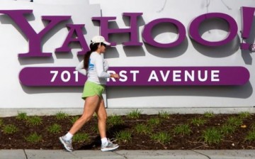 A woman jogs past Yahoo's logo at its headquarters in Sunnyvale, California.