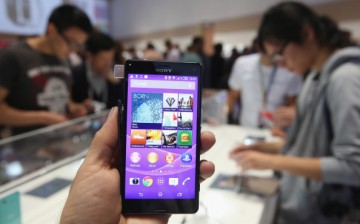 The photographer holds up a Sony Xperia Z3 smartphone at the Sony stand at the 2014 IFA home electronics and appliances trade fair on September 5, 2014 in Berlin, Germany. 