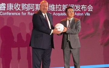 Chinese business tycoon Tony Xia (right) being welcomed by Aston Villa director Keith Wyness as the new owner of the team during a press conference in Beijing.