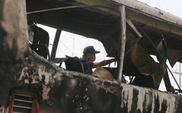 Investigators checking the wreckage of a tour bus that caught fire and killed 26 people in Taoyuan, Taiwan.