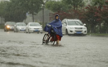 Heavy rains in Beijing have prompted the government to issue orange alert status.