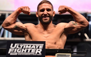 Chad Mendes flexes his biceps during a UFC weigh-in last December 2015