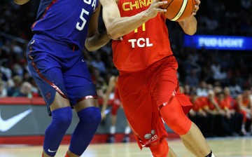Kevin Durant of the United States defends Yi Jianlian of China during the USA-China exhibition gamein Los Angeles