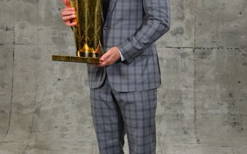 Cavaliers head coach Tyronn Lue poses with the NBA Championship trophy after winning the 2016 NBA title against the Golden State Warriors.