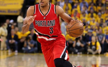 C.J. McCollum of the Portland Trail Blazers dribbles the ball in a game against the Golden State Warriors in Oakland.