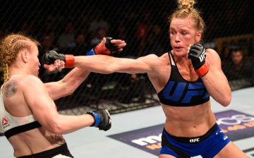 Holly Holm punches Valentina Shevchenko of Kyrgyzstan in their women's bantamweight bout during the UFC Fight Night event at the United Center on July 23, 2016 in Chicago, Illinois. 
