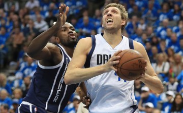 Dallas Mavericks power forward Dirk Nowitzki (R) drives past Oklahoma City Thunder's Serge Ibaka.