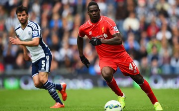 Liverpool striker Mario Balotelli (R).