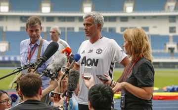 Manchester United manager Jose Mourinho (middle) talks to reporters during the team's recent China visit.