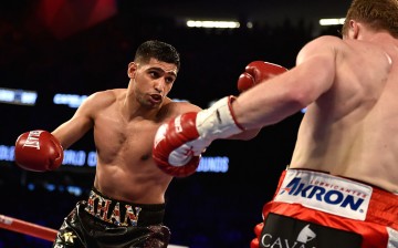 Amir Khan (L) and Canelo Alvarez battle during a WBC middleweight title fight at T-Mobile Arena on May 7, 2016 in Las Vegas, Nevada.