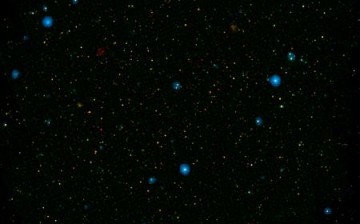 The blue dots in this field of galaxies, known as the COSMOS field, show galaxies that contain supermassive black holes emitting high-energy X-rays. They were detected by NASA's Nuclear Spectroscopic Array, or NuSTAR, which spotted 32 such black holes in 
