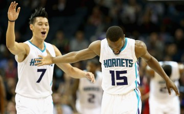 Teammates Jeremy Lin #7 and Kemba Walker #15 of the Charlotte Hornets react after a play during their game against the Chicago Bulls at Time Warner Cable Arena on October 19, 2015 in Charlotte, North Carolina.
