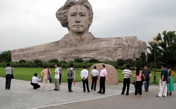 Face-to-face: Tourists gather near the bust of a young Mao Zedong and his wind-blown hair in Orange Isle in Changsha, Hunan Province. The isle loses its 5A tourist attraction rating this month.