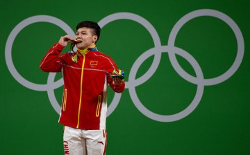 Long Qingquan of China wins the men's 56kg category of the Rio 2016 Olympic Games weightlifting events at the Riocentro in Rio de Janeiro, Brazil, Aug. 7, 2016. 