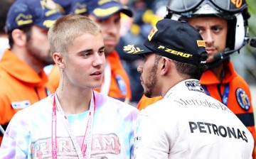 Lewis Hamilton of Great Britain and Mercedes GP talks to singer Justin Bieber at the podium during the Monaco Formula One Grand Prix at Circuit de Monaco on May 29, 2016 in Monte-Carlo, Monaco.  