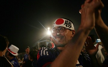 Japan supporters celebrate after their first goal against Colombia while watching at the FIFA Fan Fest on Copacabana Beach on June 24, 2014 in Rio de Janeiro, Brazil.