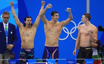  Cody Miller, Michael Phelps and Ryan Murphy of the United States celebrate winning gold in the Men's 4 x 100m Medley Relay Final on Day 8 of the Rio 2016 Olympic Games. 