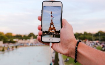 A man catches a Pokemon in a Pokeball, while playing Nintendo Co.'s Pokemon Go augmented-reality game at the Trocadero, in front of the Eiffel tower, on August 17, 2016 in Paris, France.