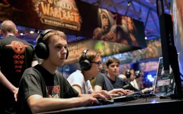 Visitors try out the massively multiplayer online role-playing game 'World Of Warcraft' at the Blizzard Entertainment stand at the 2014 Gamescom gaming trade fair on August 14, 2014 in Cologne, German