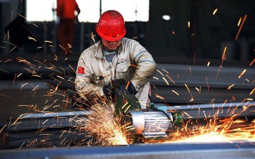 A worker polishing metal in a steel factory in Rizhao in Shandong Province.