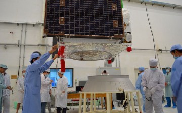 Technical staff put on a rocket adaptor to the quantum communication satellite at the Jiuquan Satellite Launch Center in Jiuquan, Gansu Province.