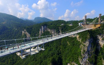 An aerial photo shows tourists visiting the glass-bottom bridge at Zhangjiajie Grand Canyon on Saturday.
