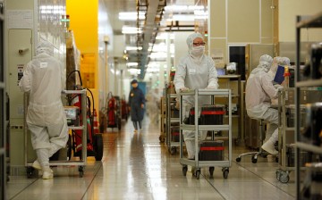 Workers operate in the wafer division of Semiconductor Manufacturing International Corp in Shanghai, one of the largest chip foundries in the world.