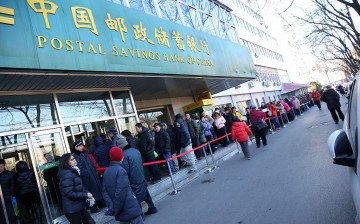 People line up outside the Postal Bank of China in Beijing to buy stamps for the Year of the Monkey celebration in January.