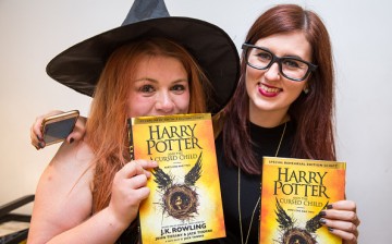 Women pose for copies of J. K. Rowling's 'Harry Potter and The Cursed Child' a little after midnight at Foyles book store on July 31, 2016 in London, England.   