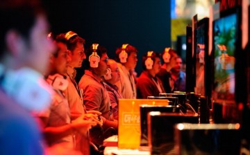 Gamers and show attendees play video games at the XBOX 360 booth during the Electronic Entertainment Expo on June 7, 2011 in Los Angeles, California.