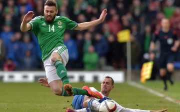 Stuart Dallas (L) of Northern Ireland is tackled by Sakari Mattila (R) of Finland during the EURO 2016 Group F qualifier at Windsor Park on March 29, 2015 in Belfast, Northern Ireland. (Photo by Charles McQuillan/Getty Images)