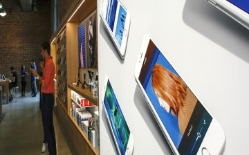 A poster that contains pictures of iPhones is displayed the new Brooklyn Apple Store during a media preview in the Williamsburg neighborhood of Brooklyn on July 28, 2016 in New York City. The Williamsburg Apple Store opens next Saturday on July 30th, it i