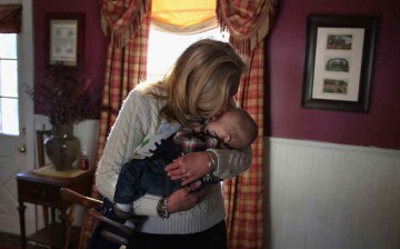 Kim Sullivan kisses her grandson during a family gathering to mark the first anniversary of the death of her son (the baby's father), Benjamin Comparone, 27 who died of heroin overdose. The photo has been snapped at Plainville, Connecticut on March 6, 201