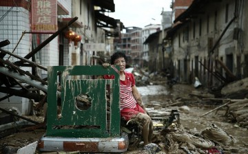 A woman sits amid the destruction left behind by Typhoon Nepartak in China.