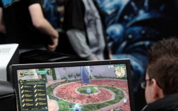 Visitors play World of WarCraft in the gaming hall at the CeBIT Technology Fair.