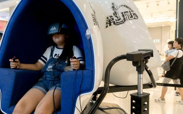 A child plays a game using a VR device in a mall in China, the next battleground for VR markets.