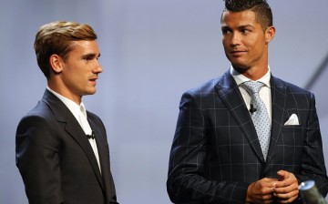 Real Madrid's Portuguese forward Cristiano Ronaldo (R) looks at Atletico Madrid's French forward Antoine Griezmann at the end of the UEFA Champions League Group stage draw ceremony.