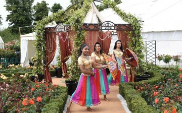 Bollywood style dancers perform in the Fryer'd Roses garden during the launch of the RHS Hampton Court Flower Show at Hampton Court Palace on July 4, 2016 in London, England.   
