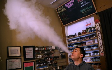 Guy blowing vapor.