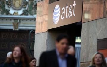 Pedestrians walk by an AT&T store on October 23, 2013 in San Francisco, California. 