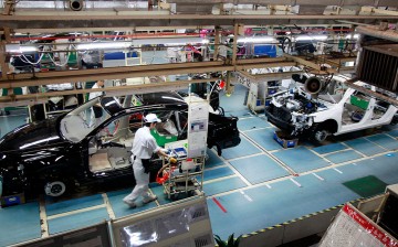 A worker checks a car in the GAC assembly plant in Guangzhou, Guandong Province.