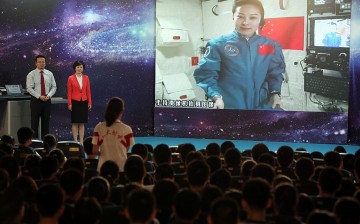 Chinese female taikonaut Wang Yaping answers a  student's question from Tiangong-1 space module in June 2013.