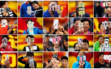 People take pictures of themselves in Tian'anmen Square as they celebrate the National Day marking the 67th anniversary of the founding of the People's Republic of China, in Beijing on Oct. 1, 2016.
