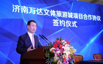 Dalian Wanda Group chairman Wang Jianlin speaks during a signing ceremony on Aug. 26 in Jinan.
