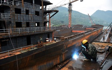 A worker welds parts of a ship in a shipyard in Chongqing.